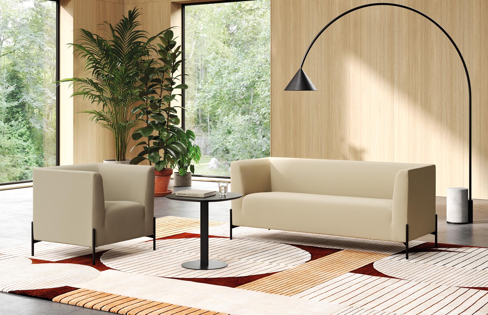 Clint reception seating: beige fabric armchair and three-seater sofa on black steel feet, in a lounge with wooden walls