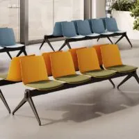Yo Plastic Bench waiting room bench seats for 5 people, orange polypropylene shells with green fabric cushions and black inverted V legs, in a Frezza waiting area