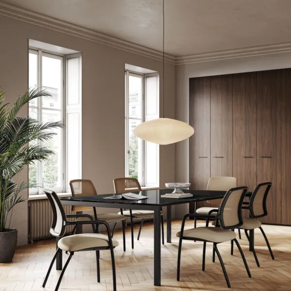 Six Charlize Black office chairs without wheels, mesh back and beige seat, around a black table on herringbone parquet